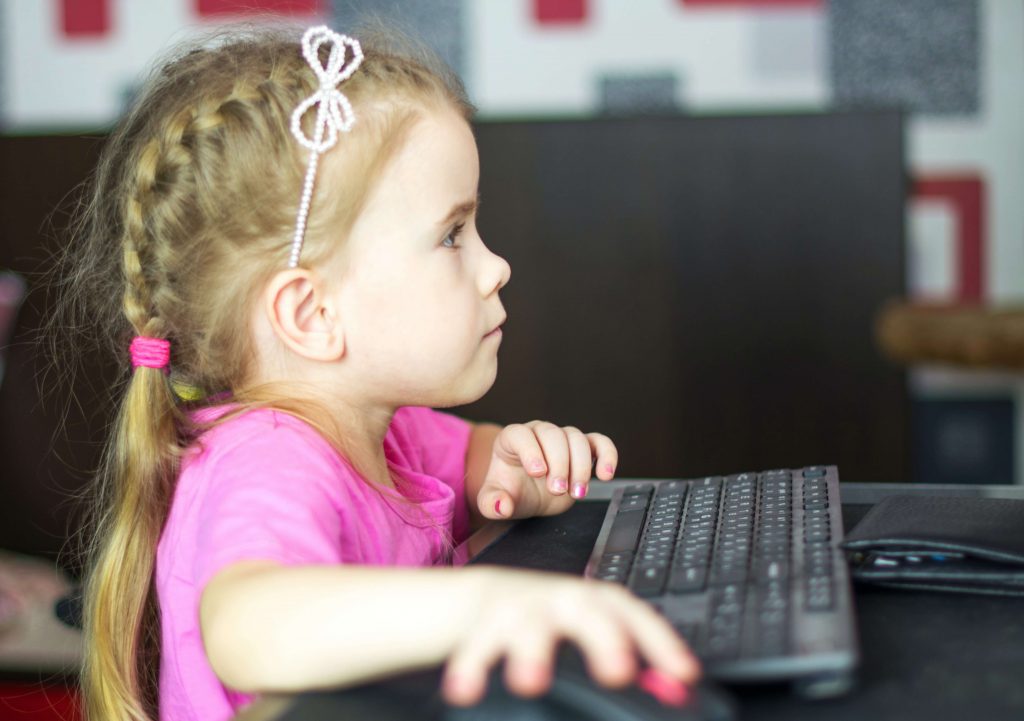 Young girl at the computer testing fer offer on Facebook